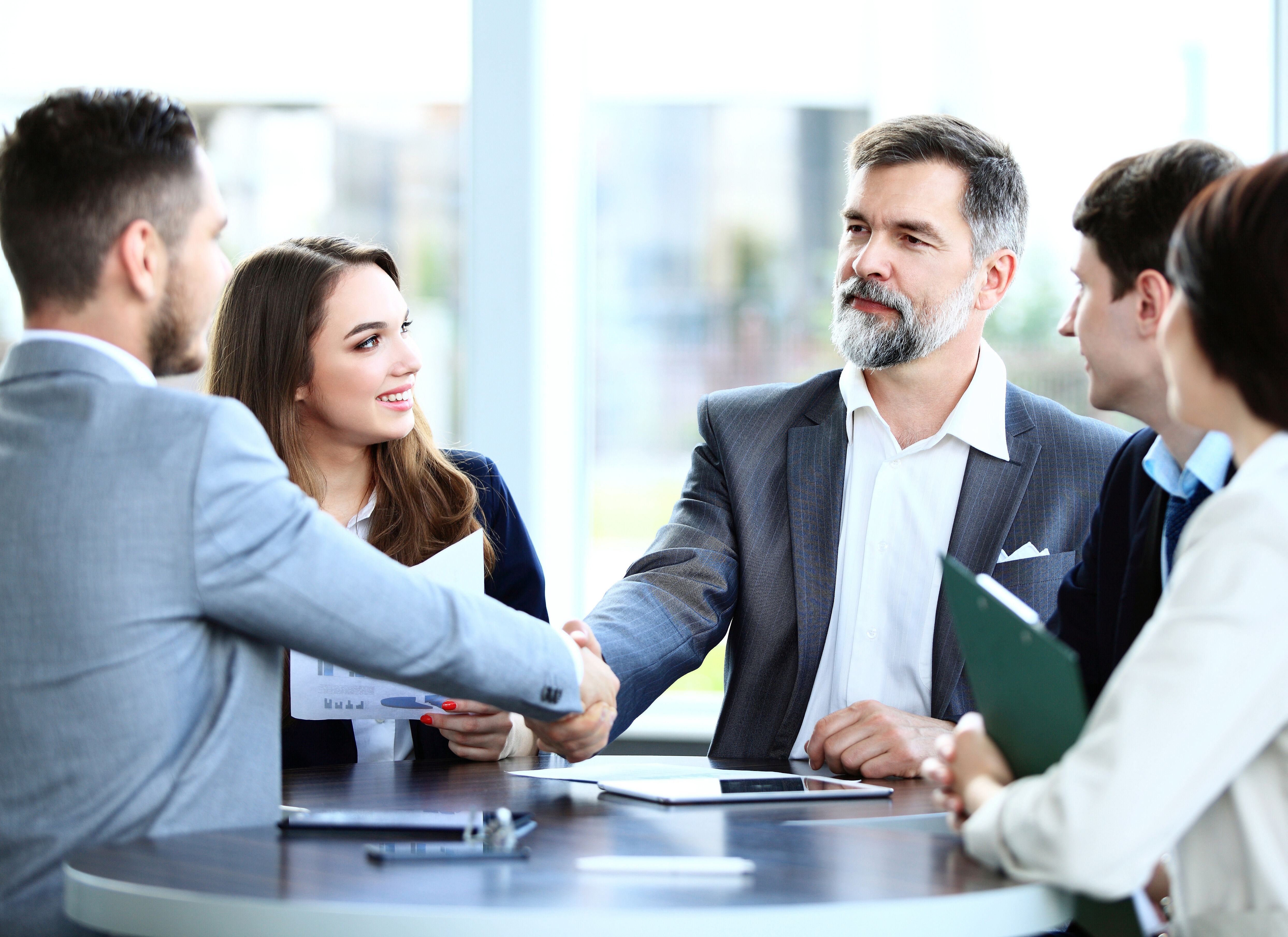 Business people shaking hands, finishing up a meeting 